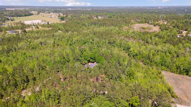 drone / aerial view featuring a view of trees
