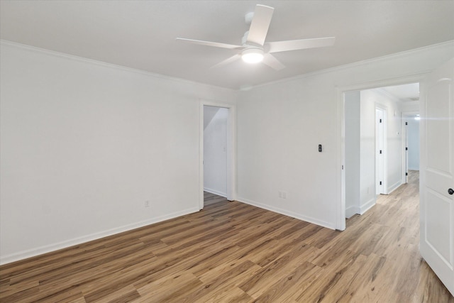 empty room featuring ceiling fan, light wood-type flooring, ornamental molding, and baseboards