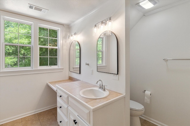 bathroom featuring toilet, visible vents, baseboards, and a healthy amount of sunlight