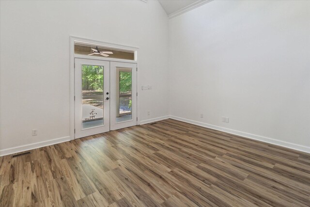 interior space with wood finished floors, visible vents, ceiling fan, and baseboards