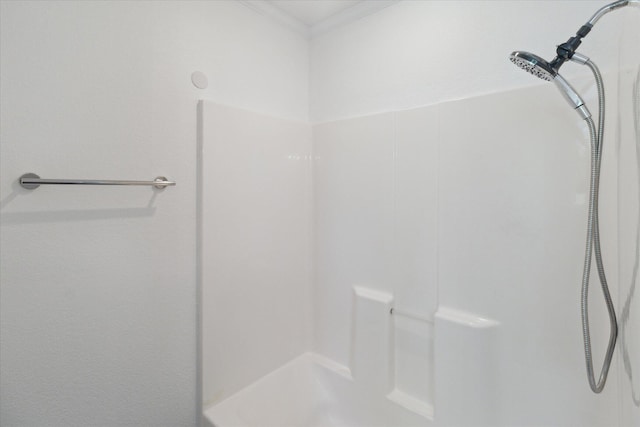 bathroom featuring walk in shower and ornamental molding