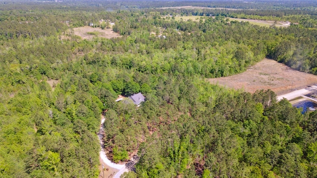 birds eye view of property featuring a view of trees