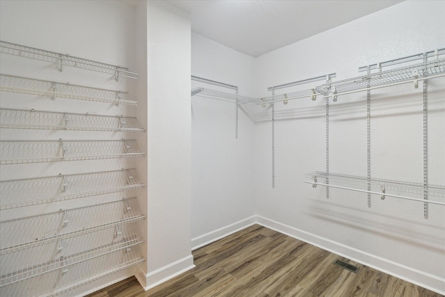 spacious closet featuring visible vents and wood finished floors