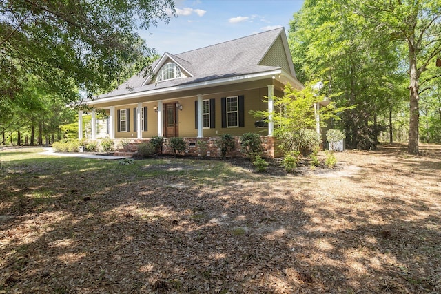 farmhouse with a porch and roof with shingles