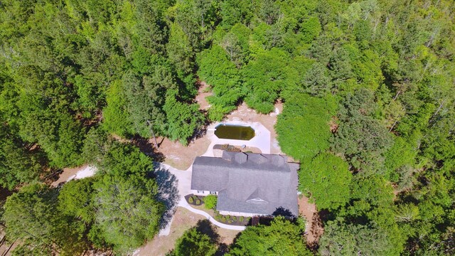 bird's eye view with a wooded view