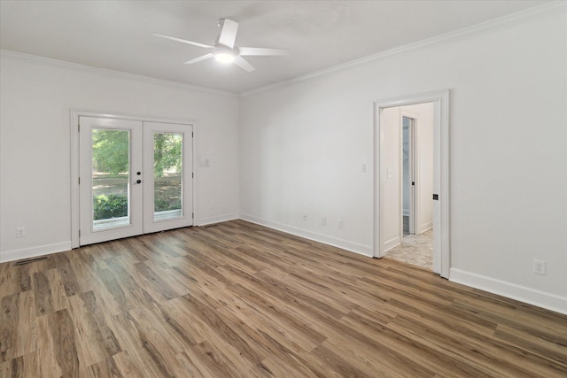 empty room featuring crown molding, french doors, baseboards, wood finished floors, and a ceiling fan