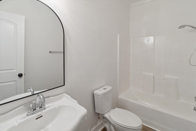 full bathroom featuring ornamental molding, toilet, and a sink