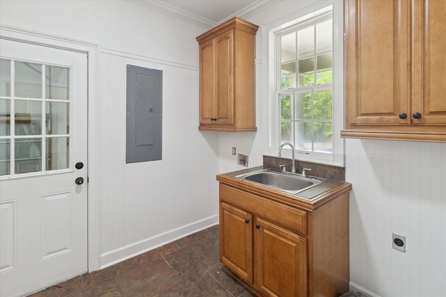 clothes washing area with cabinet space, hookup for an electric dryer, electric panel, a sink, and crown molding