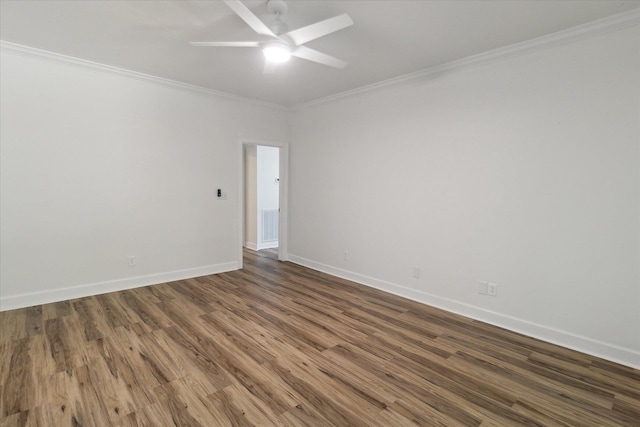 spare room featuring wood finished floors, a ceiling fan, ornamental molding, and baseboards