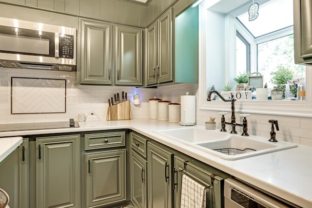 217 Longmeadow Rd, North Augusta, SC 29860 - kitchen featuring stainless steel microwave, green cabinets, dishwasher, and backsplash