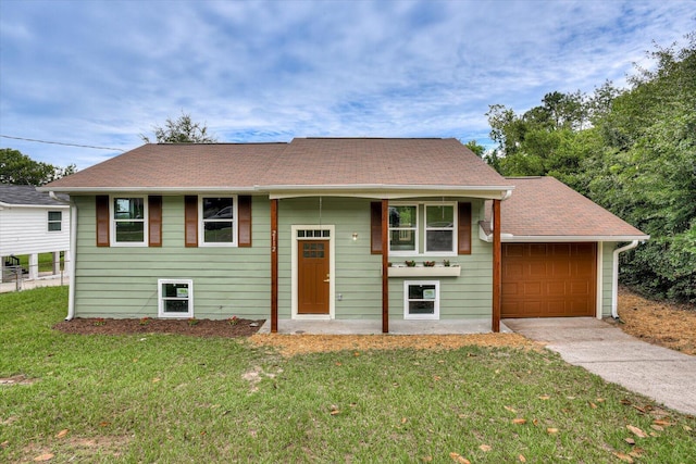 raised ranch with a front yard and a garage