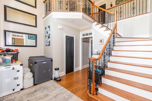 701 Fosters Ct, Evans, GA 30809 - stairway with crown molding, wood finished floors, and baseboards