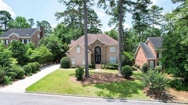 701 Fosters Ct, Evans, GA 30809 - view of front facade featuring stucco siding, stone siding, a front yard, and a chimney