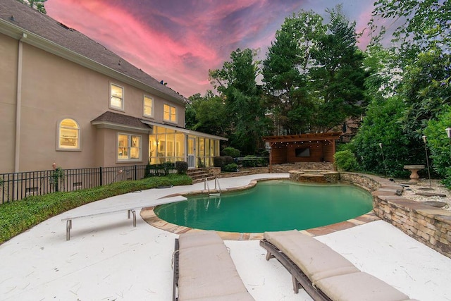 701 Fosters Ct, Evans, GA 30809 - pool at dusk featuring a patio area, a pool with connected hot tub, a pergola, and a diving board