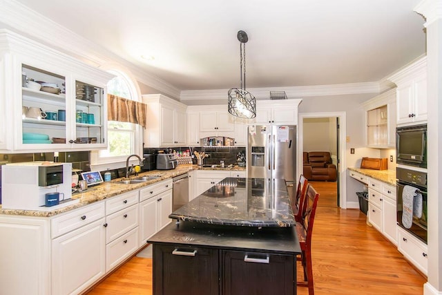 701 Fosters Ct, Evans, GA 30809 - kitchen featuring black appliances, a sink, white cabinetry, glass insert cabinets, and light wood finished floors