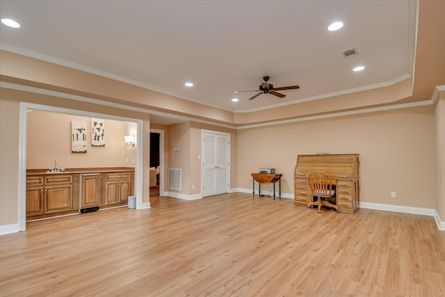 living room featuring a ceiling fan, ornamental molding, and light wood-style flooring