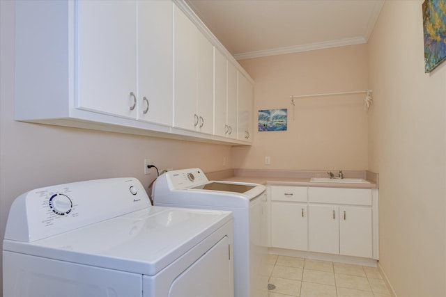 washroom featuring crown molding, separate washer and dryer, a sink, cabinet space, and light tile patterned floors