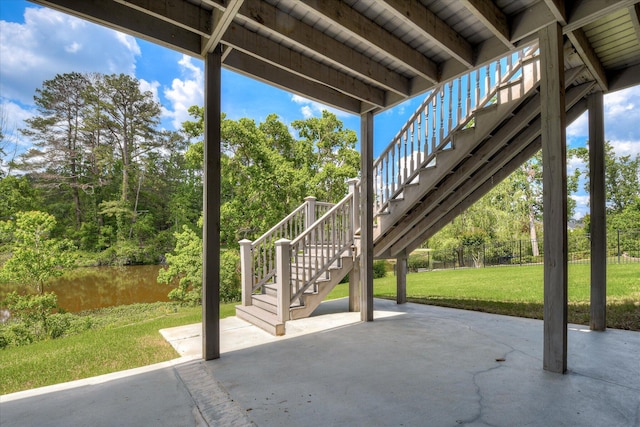 view of patio featuring stairway and fence