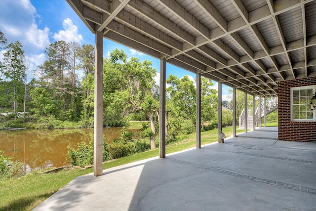 view of patio / terrace featuring stairs and a water view
