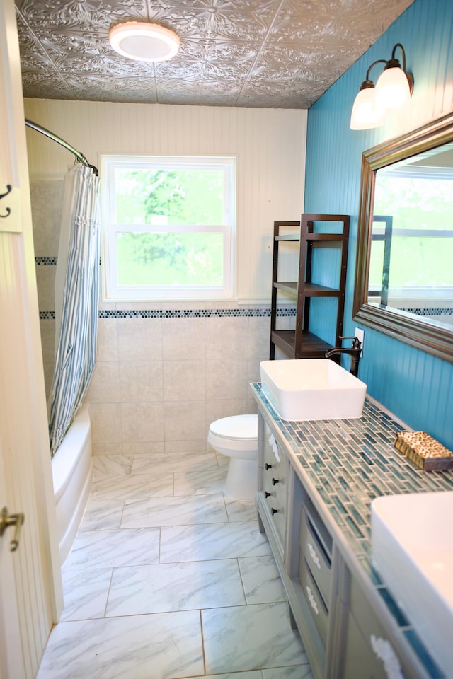 bathroom with double vanity, shower / tub combo, a sink, an ornate ceiling, and toilet