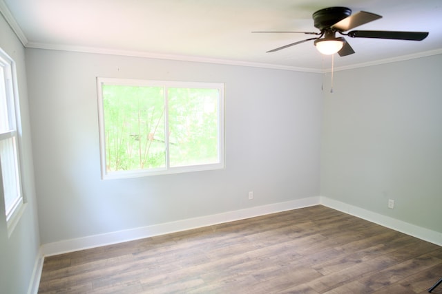 unfurnished room with ornamental molding, wood finished floors, and a healthy amount of sunlight
