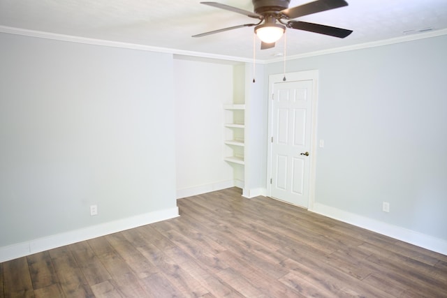unfurnished room with baseboards, crown molding, ceiling fan, and wood finished floors