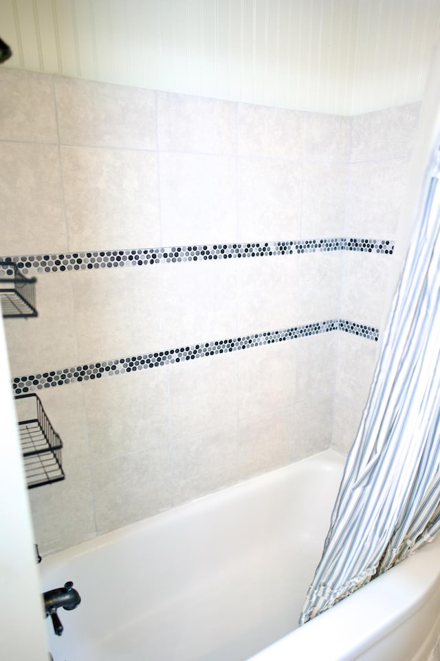 bathroom with shower / bath combination with curtain