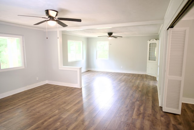 spare room featuring baseboards, ceiling fan, ornamental molding, and dark wood-style flooring