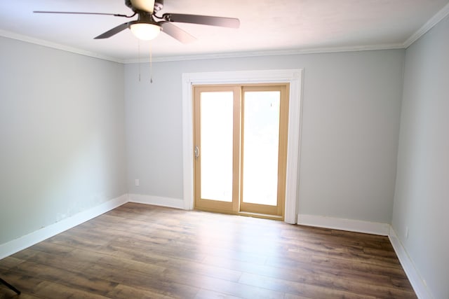 empty room with baseboards, plenty of natural light, a ceiling fan, and dark wood-style floors