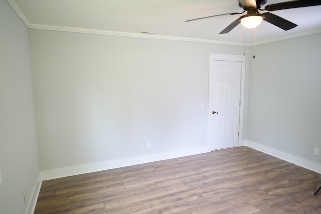 empty room with visible vents, crown molding, ceiling fan, and wood finished floors