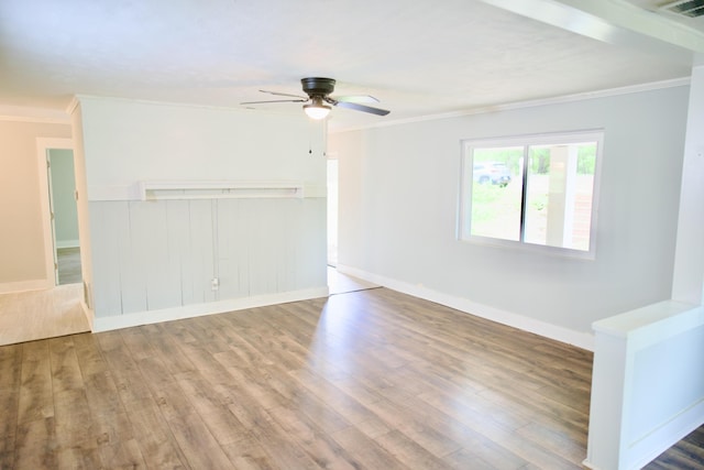 empty room with crown molding, a ceiling fan, and wood finished floors