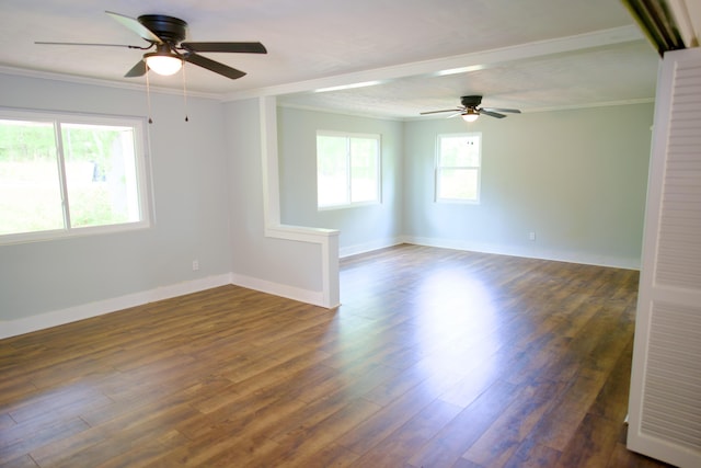 empty room featuring crown molding, a ceiling fan, and dark wood-type flooring
