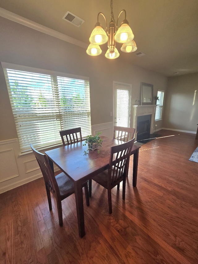 2144 Willhaven Dr, Augusta, GA 30909 - dining area featuring a chandelier, plenty of natural light, dark wood-type flooring, a wainscoted wall, and a fireplace