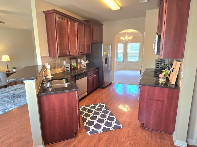 2144 Willhaven Dr, Augusta, GA 30909 - kitchen with arched walkways, dishwasher, light wood-style floors, stainless steel fridge with ice dispenser, and a peninsula