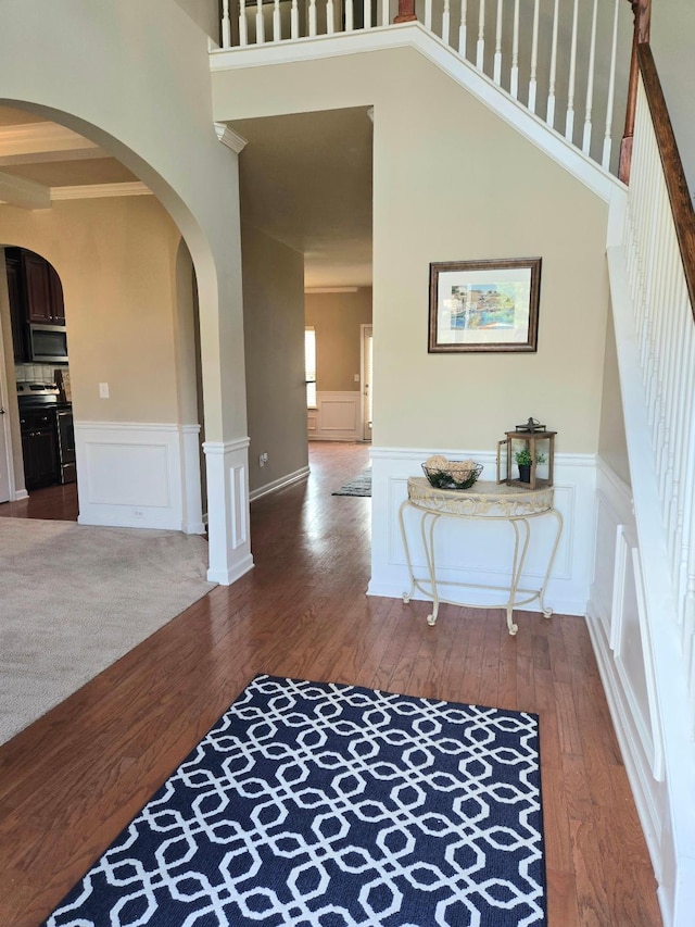 2144 Willhaven Dr, Augusta, GA 30909 - entrance foyer with hardwood / wood-style flooring, wainscoting, arched walkways, and a decorative wall