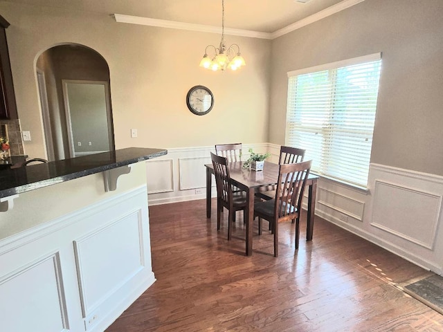 2144 Willhaven Dr, Augusta, GA 30909 - dining space featuring a decorative wall, crown molding, a wainscoted wall, arched walkways, and dark wood-style flooring