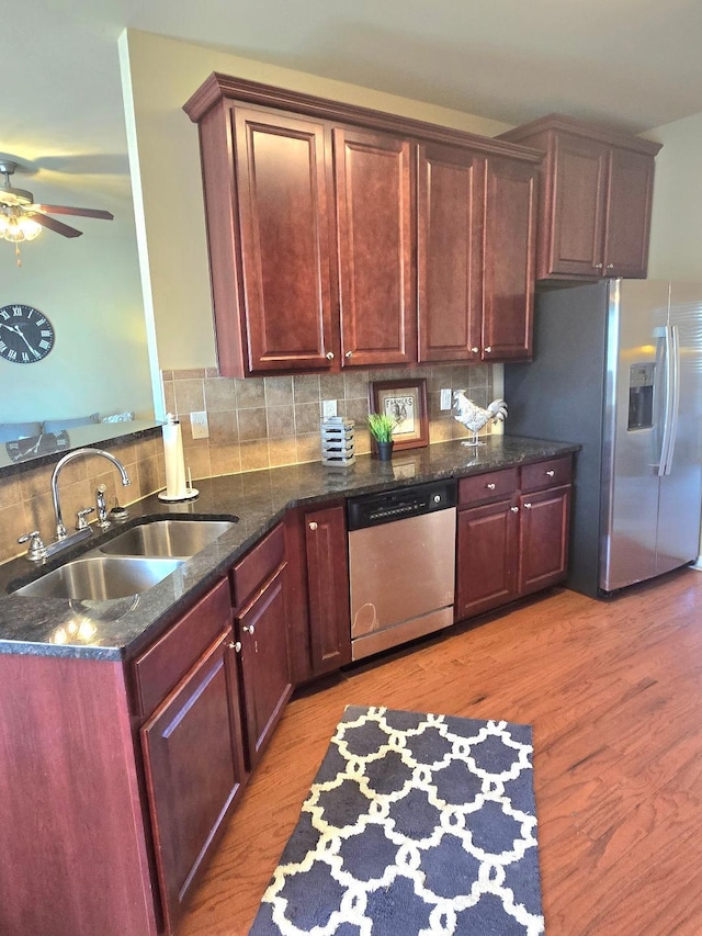 2144 Willhaven Dr, Augusta, GA 30909 - kitchen featuring stainless steel appliances, ceiling fan, light wood-style flooring, decorative backsplash, and dark stone counters