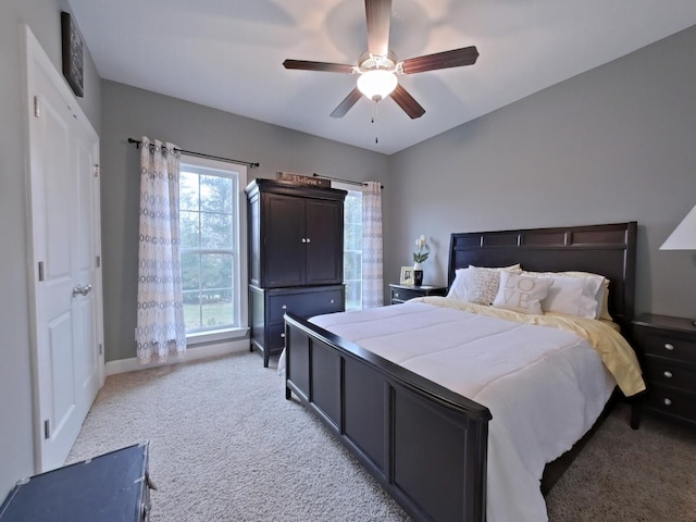 bedroom with ceiling fan and light carpet