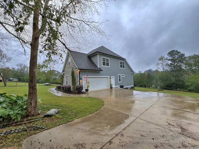 view of side of property featuring a yard and a garage