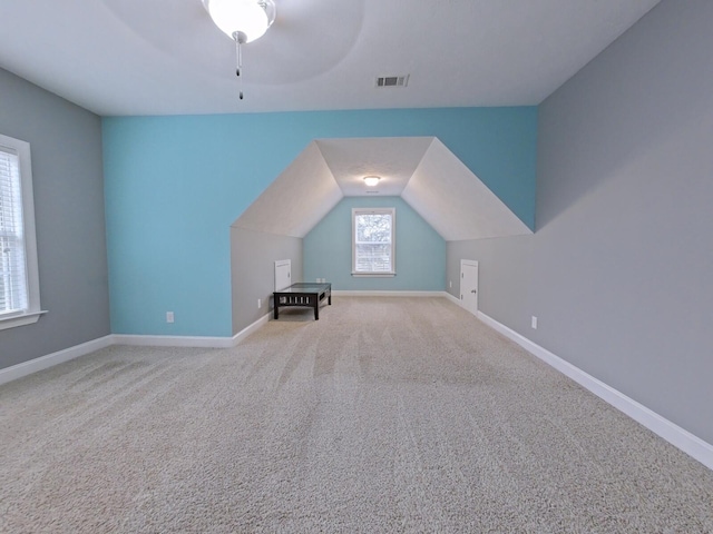 bonus room with ceiling fan, carpet, and lofted ceiling