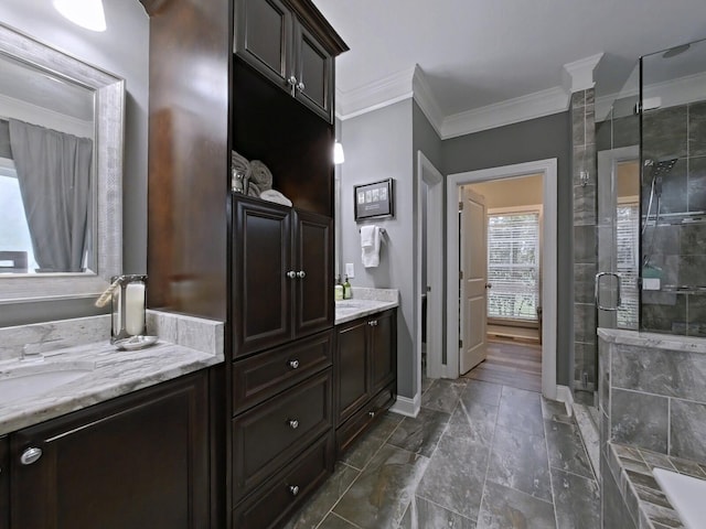 bathroom featuring vanity, a shower with shower door, and ornamental molding