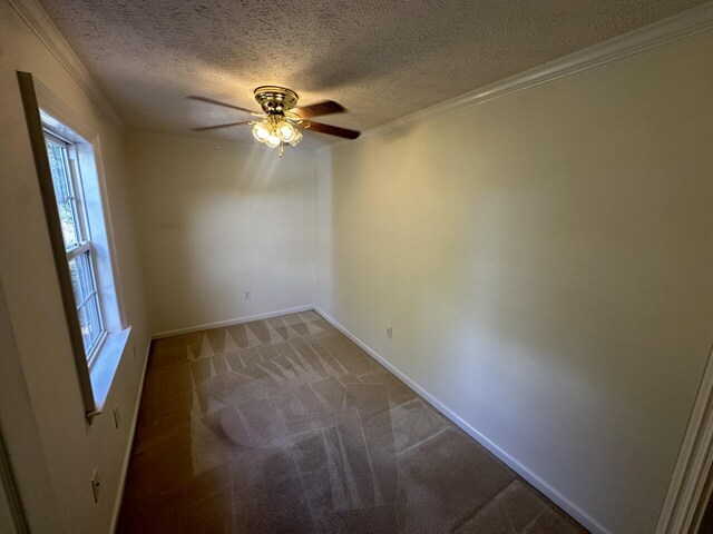 unfurnished room featuring a textured ceiling, carpet floors, ceiling fan, and ornamental molding