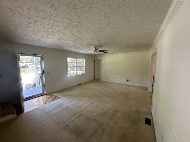 interior space with ceiling fan, light colored carpet, a textured ceiling, and ornamental molding