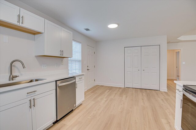 4002 Hidden Haven Ct, Augusta, GA 30909 - kitchen with appliances with stainless steel finishes, a sink, light countertops, light wood-type flooring, and white cabinets