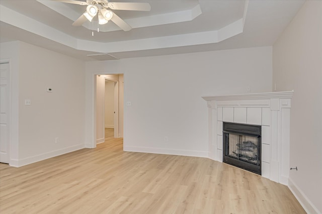 4002 Hidden Haven Ct, Augusta, GA 30909 - unfurnished living room with a raised ceiling, a ceiling fan, and light wood-style flooring