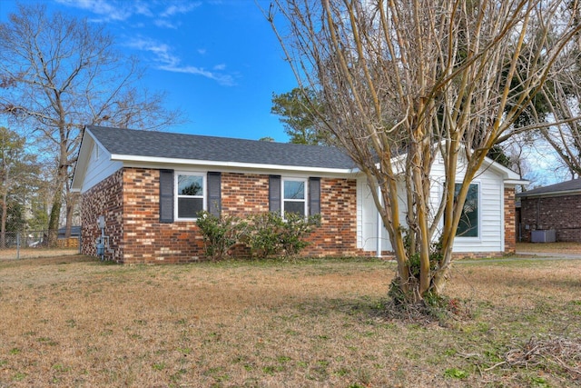 view of front of house with a front yard and cooling unit