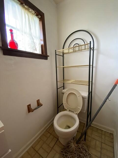 1012 14th Ave, Augusta, GA 30901 - bathroom with brick patterned flooring, toilet, and baseboards