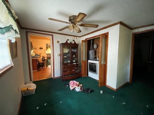1012 14th Ave, Augusta, GA 30901 - interior space with ceiling fan, crown molding, dark carpet, and baseboards