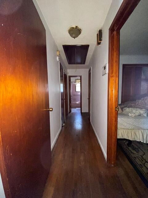 1012 14th Ave, Augusta, GA 30901 - hall featuring wood finished floors, baseboards, and attic access