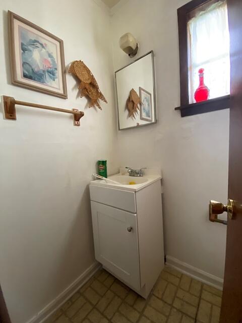 1012 14th Ave, Augusta, GA 30901 - bathroom with vanity, brick patterned flooring, and baseboards